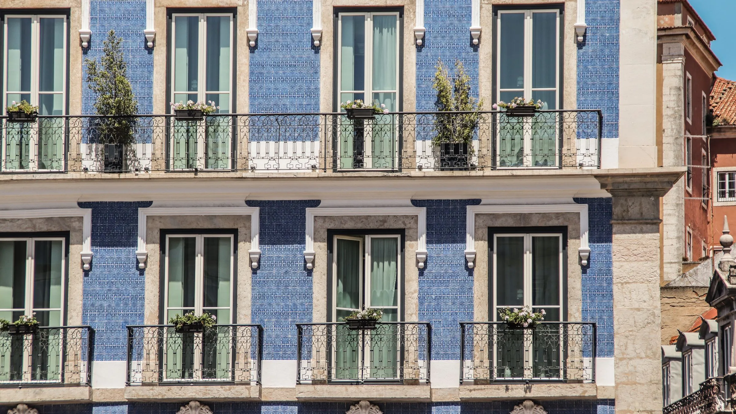 Lisbon building facade with traditional blue tiles and balconies